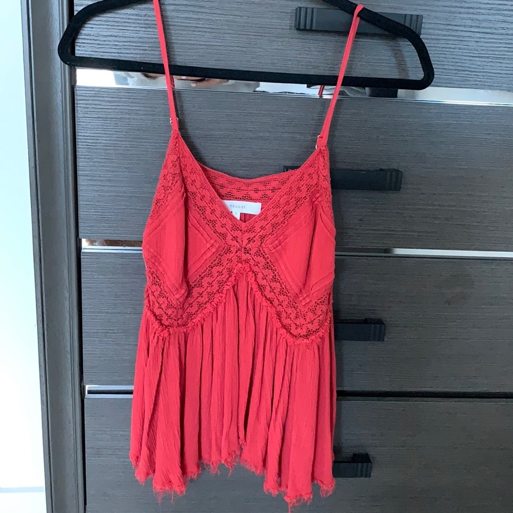 Taylor’s red flowy tank top